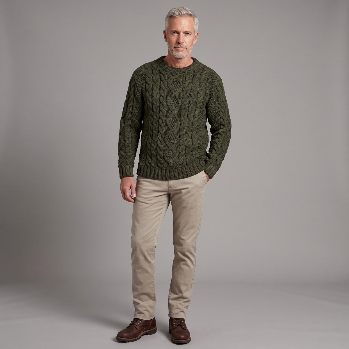 Men's Aran cable knit sweater in army green, full-body standing shot