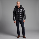 Men's glossy hooded puffer jacket in black, full-body standing shot