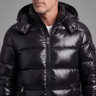 Men's glossy hooded puffer jacket, close-up of high-shine quilted shell and zip