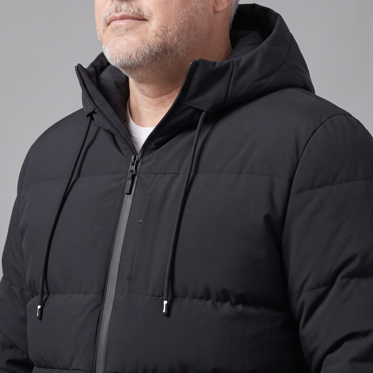 Men's big and tall padded jacket, close-up of drawcord hood and chest zip pocket