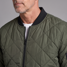 Men's diamond-quilted bomber jacket, close-up of quilting and ribbed collar