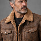 Men's vegan suede sherpa-lined jacket, close-up of suede and sherpa texture, gray studio background