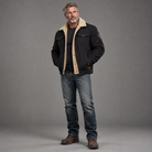 Men's sherpa-lined trucker jacket, full-body standing shot, gray studio background