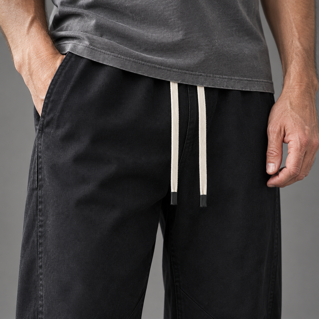 Men's cotton relaxed pants, close-up of fabric and drawstring waist