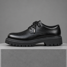 Men's faux leather lug-sole derby shoes, straight-on gray pedestal shot
