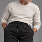 Men's woven blend joggers, close-up of fabric texture and drawstring waist