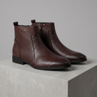 Men's pointed-toe side-zip leather boots in dark brown, 3/4 angle gray pedestal shot